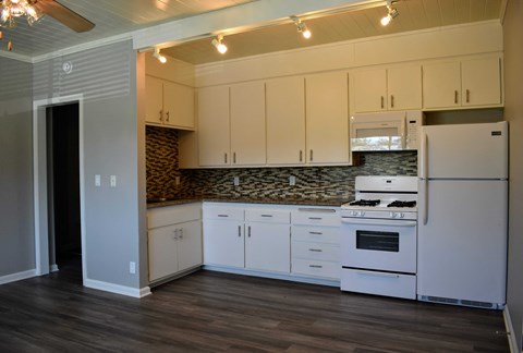 a kitchen with white appliances and white cabinets